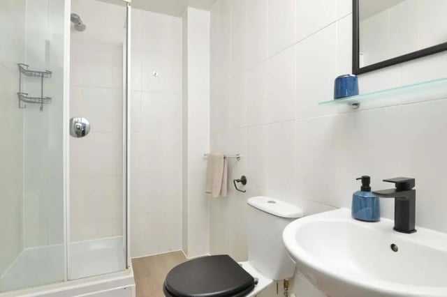 Shower toilet sink with black faucet and soap dispenser bathroom at Isca Lofts in Exeter Student Accommodation
