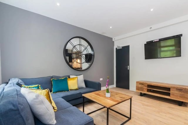 Blue sectional sofa with colorful pillows living room at Bankfield in Huddersfield Student Accommodation