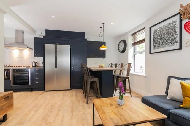 Modern kitchen with dining island and sofa Living room at Bankfield in Huddersfield Student Accommodation