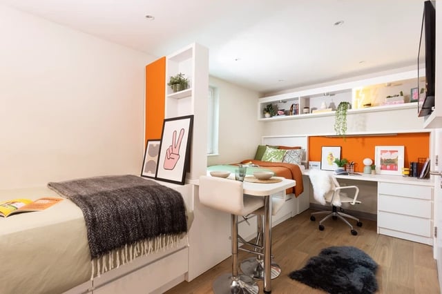 Two beds desk chair shelving unit student room at Drapery Place in London Student Accommodation