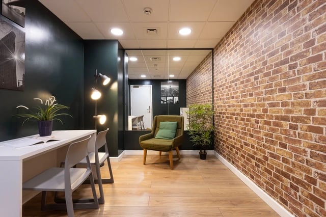White desk chairs plant accent chair lounge area at Drapery Place in London Student Accommodation