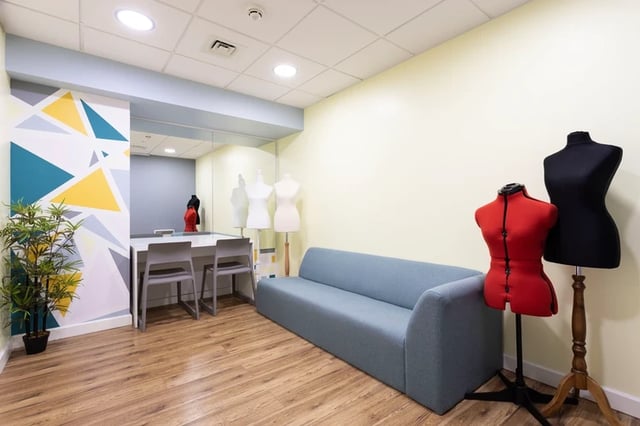 Sofa study tables mannequins and plant common room at Drapery Place in London Student Accommodation