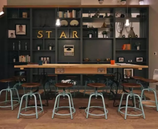 Bar with stools and large bookshelf common area at College Green in Bristol Student Accommodation