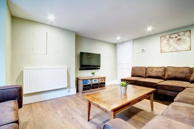 Sofa television wooden table radiator living room at 131 Hyde Park in Leeds Student Accommodation