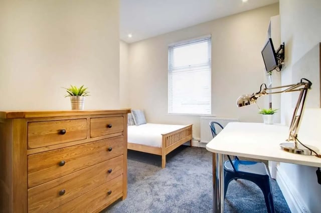 Wooden dresser bed desk lamp and chair bedroom at 131 Hyde Park in Leeds Student Accommodation