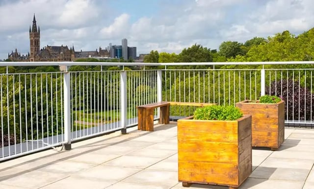 Wooden planters bench and cityscape view balcony exterior at Claremont House in Glasgow Student Accommodation