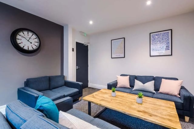 Two sofas coffee table clock framed art living room at 9 Manor Drive in Leeds Student Accommodation