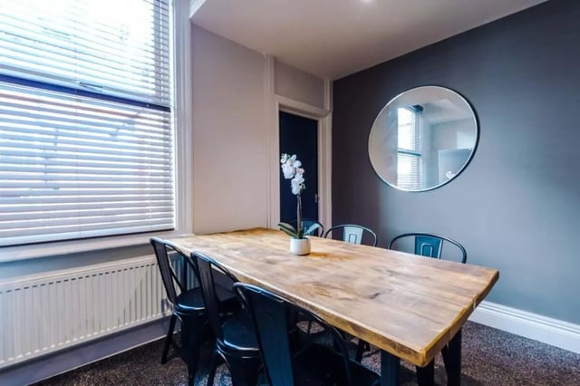 Wooden table with black chairs round mirror dining area at 9 Manor Drive in Leeds Student Accommodation