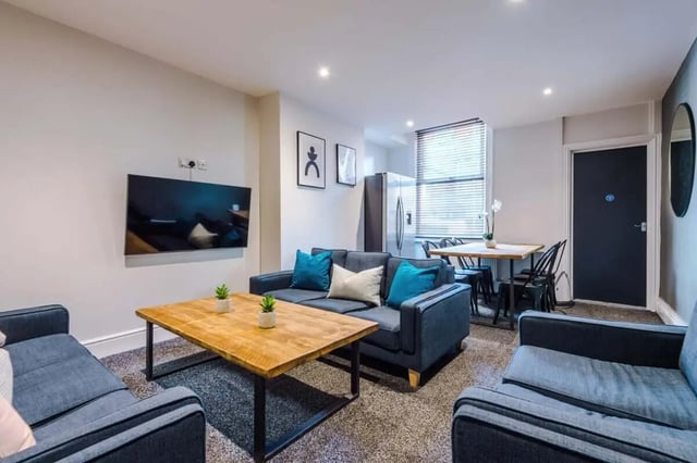Sofa coffee table TV refrigerator dining table living room at 9 Manor Drive in Leeds Student Accommodation