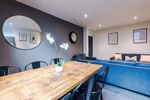 Wooden dining table with black chairs living room. at 9 Manor Drive in Leeds Student Accommodation