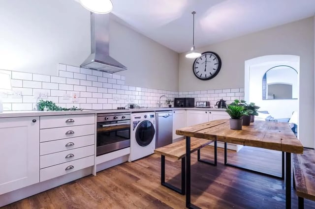 White cabinets oven washing machine dining table kitchen at The Hosiery in Leicester Student Accommodation