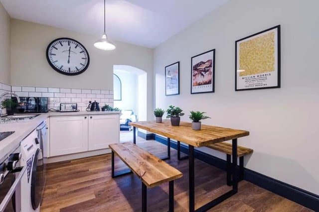 Kitchen with dining table and benches kitchen area at The Hosiery in Leicester Student Accommodation