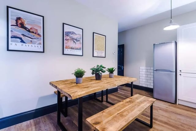 Wooden table plants pictures fridge white cabinets Kitchen at The Hosiery in Leicester Student Accommodation