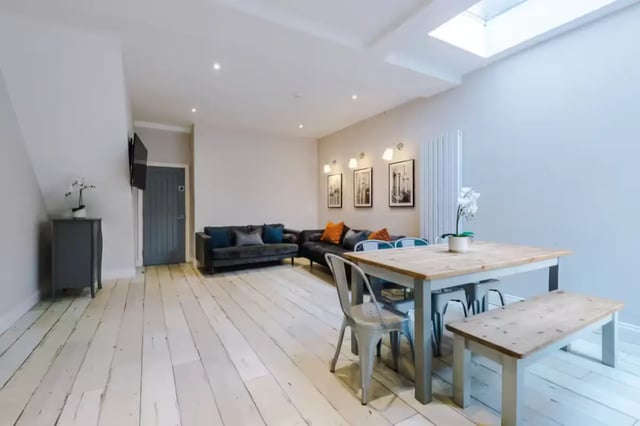 Sofa dining table chairs bench living room at 86 Woodcroft Road in Liverpool Student Accommodation
