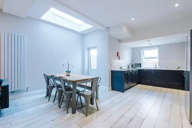 Dining table with chairs and kitchen area kitchen at 86 Woodcroft Road in Liverpool Student Accommodation