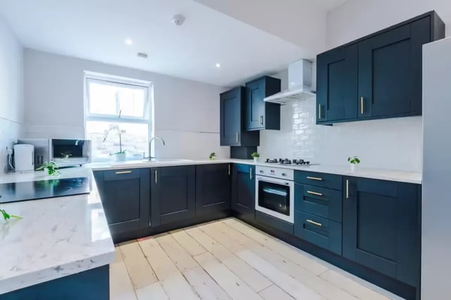 Dark cabinets oven microwave sink kitchen at 86 Woodcroft Road in Liverpool Student Accommodation