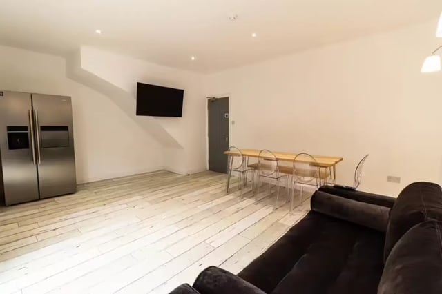 Silver fridge table chairs sofa living room at 74 Woodcroft Road in Liverpool Student Accommodation
