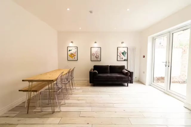 Dining table chairs sofa art living room at 74 Woodcroft Road in Liverpool Student Accommodation