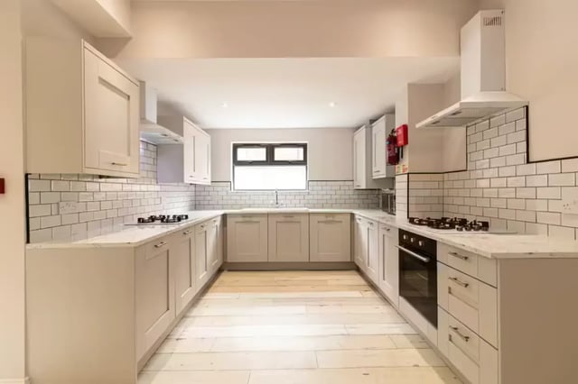 Modern kitchen with white cabinets oven stove and sink kitchen at 74 Woodcroft Road in Liverpool Student Accommodation