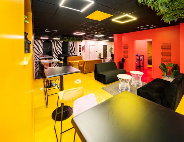 Modern lounge area with yellow floor and seating living room at Urban Hub in Preston Student Accommodation