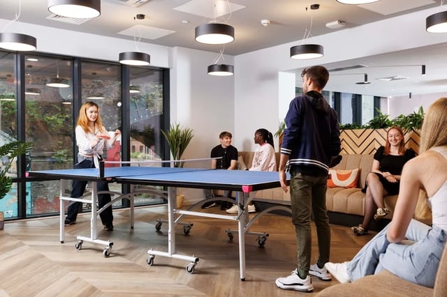 People playing ping pong in common room at Artisan Heights in Manchester Student Accommodation