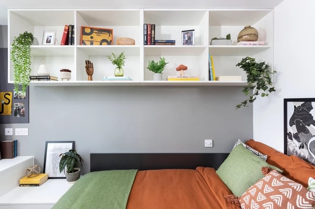 Shelving with decor above a bed bedroom area at Artisan Heights in Manchester Student Accommodation