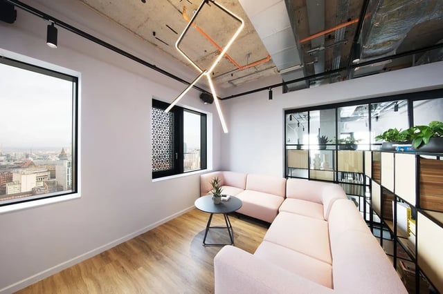 Pink sectional sofa coffee table large windows living room at Artisan Heights in Manchester Student Accommodation