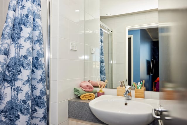 Sink towels soap dispenser and shower curtain bathroom at Broadway x Scape in Sydney Student Accommodation