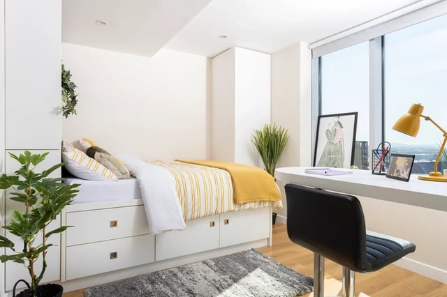 Bed with yellow blanket desk lamp chair bedroom at Bridgewater Heights in Manchester Student Accommodation