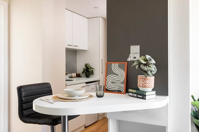 Table with chair and kitchen counter Kitchen at Bridgewater Heights in Manchester Student Accommodation