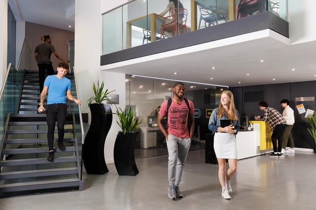 Students walking through a modern communal area at Bridgewater Heights in Manchester Student Accommodation