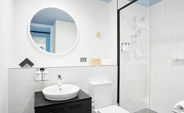 Modern bathroom with sink toilet and shower. at Scape Aurora in Melbourne Student Accommodation