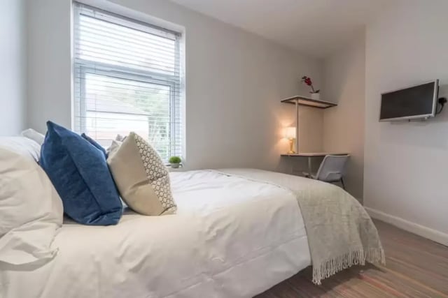 Bed with pillows desk lamp and TV bedroom at 128 Ashford Street in Stoke-On-Trent Student Accommodation