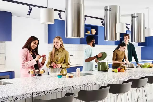 Students baking cupcakes cooking food in kitchen at Scape Lincoln College in Melbourne Student Accommodation