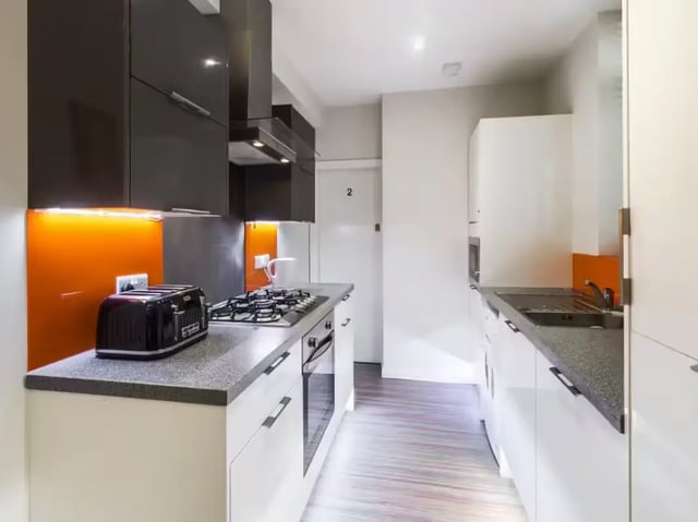 Modern kitchen with black toaster and white cabinets kitchen at 233 Leek Road in Stoke-On-Trent Student Accommodation