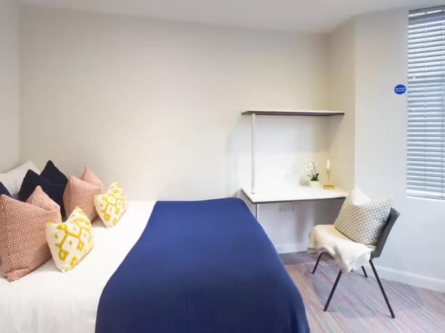 Bed with pillows study desk chair window bedroom at 233 Leek Road in Stoke-On-Trent Student Accommodation