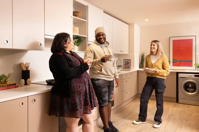 Students chatting in modern communal kitchen space at Bromley Place in Nottingham Student Accommodation
