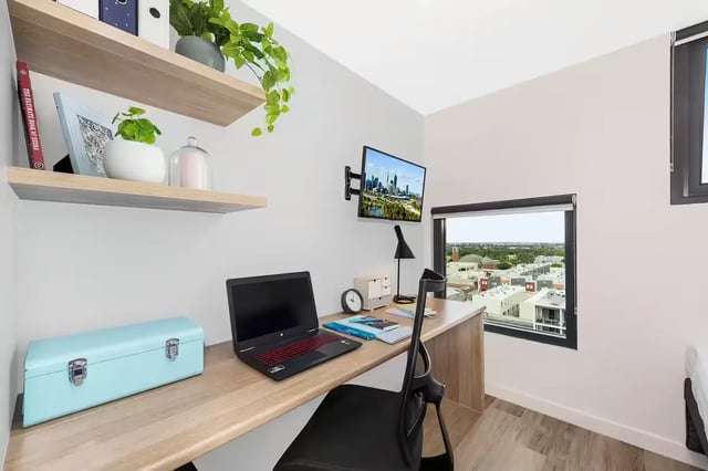 Desk with laptop and storage boxes study area at Scape Waymouth in Adelaide Student Accommodation