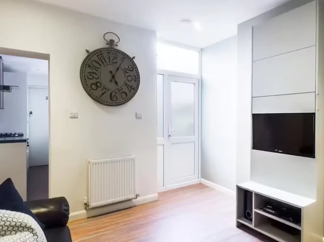 Large clock radiator and TV living room at 125 Ashford Street in Stoke-On-Trent Student Accommodation