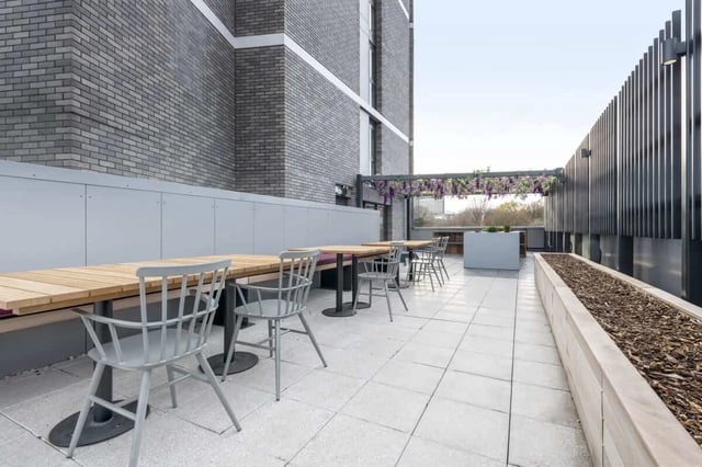 Wooden tables and chairs on patio exterior at Hillside House Sheffield in Sheffield Student Accommodation