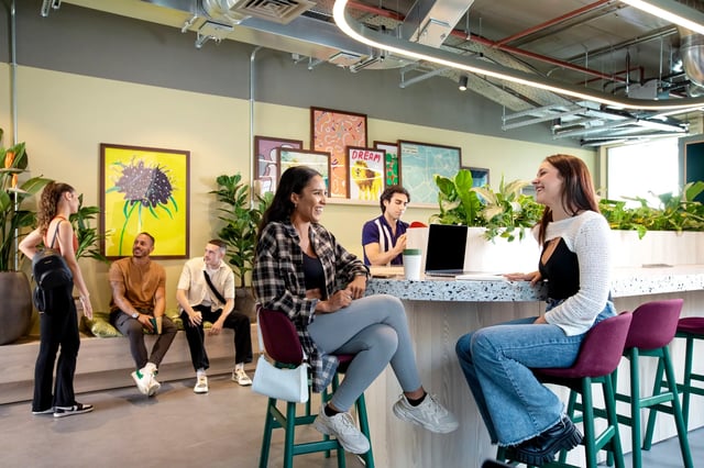 Students socialize and work at a communal table living room at Morriss House in Nottingham Student Accommodation