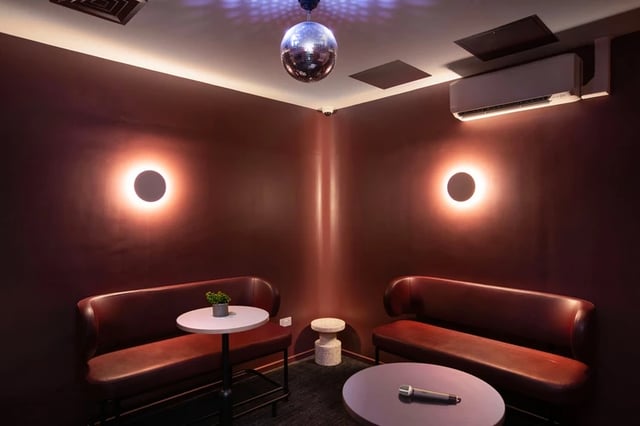 Two red benches tables disco ball playing area at Morriss House in Nottingham Student Accommodation