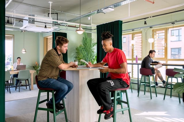 Students at counter with laptops and books common area at Morriss House in Nottingham Student Accommodation