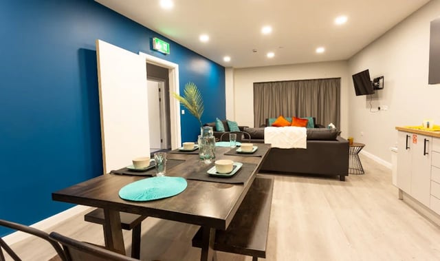 Dining table with place settings and sofa living area Kitchen at Electric Press in Sheffield Student Accommodation