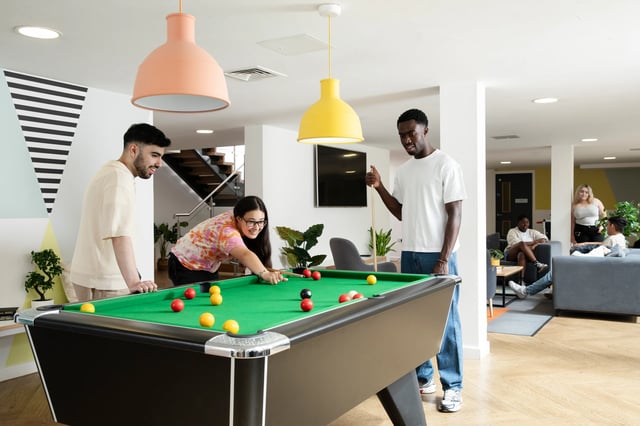 People playing pool and relaxing in common area at Beech House in Oxford Student Accommodation