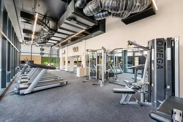 Treadmills and weight machines in gym playing area at Scape La Trobe in Melbourne Student Accommodation
