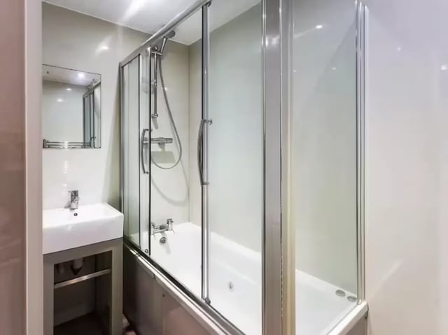 White sink and bathtub with shower screen bathroom at 48 Cauldon Road in Stoke-On-Trent Student Accommodation