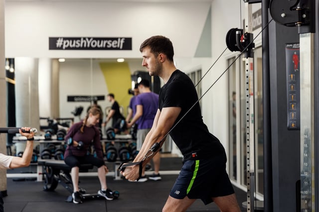 Gym with people exercising and weight racks gym at Chaucer House in Portsmouth Student Accommodation