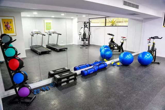 Gym equipment including treadmills stationary bikes and medicine balls Gym at Scape Regent in Brisbane Student Accommodation