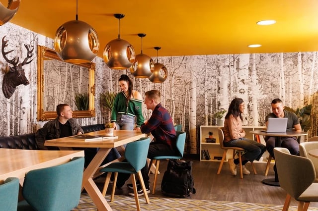 Students at tables with laptop study area at Brass Founders in Sheffield Student Accommodation